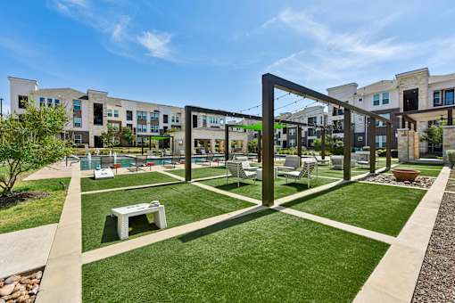 A modern building with a green lawn in front.
