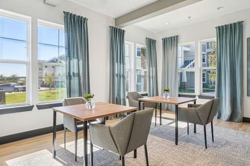 A dining room with a table and chairs.