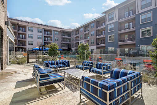 A sunny day at the outdoor seating area of a modern apartment complex.