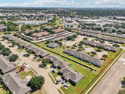 A bird's eye view of a residential area with houses and streets.
