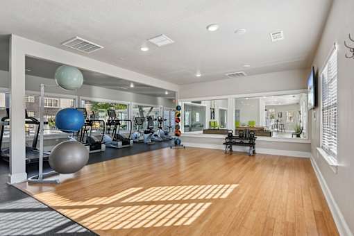 A gym with a variety of exercise equipment.