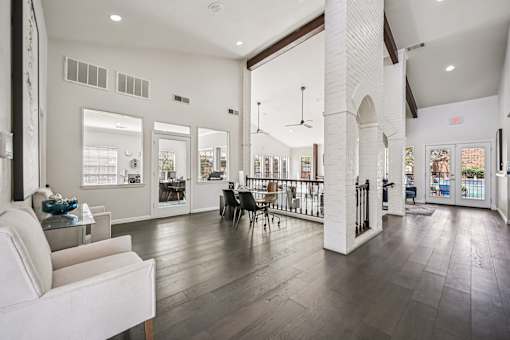 A white couch is in a room with a white column.