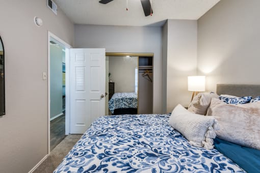 a bedroom with a large bed and a closet