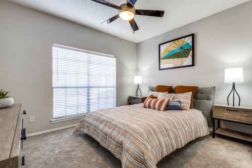 a bedroom with a bed and a ceiling fan
