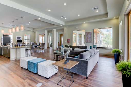 A modern living room with a grey couch and a wooden floor.