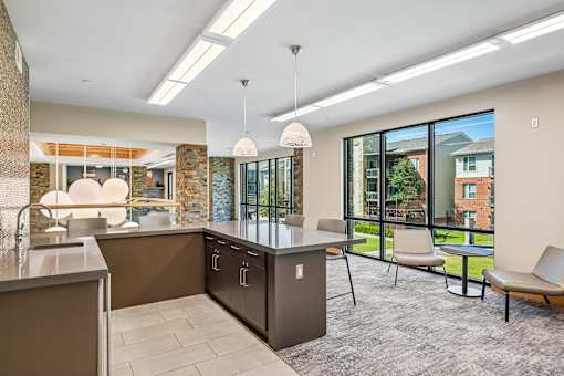A modern kitchen with a large island and a view of the backyard.