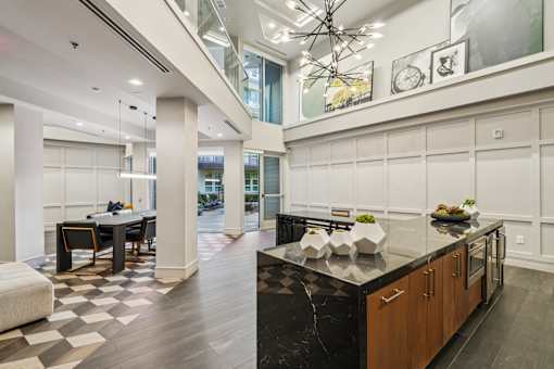 A modern kitchen with a black countertop and wooden cabinets.