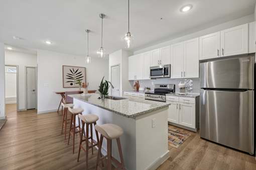 A kitchen with a bar area and stools.