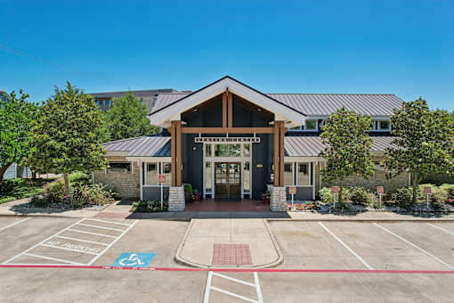 A building with a parking lot in front of it.