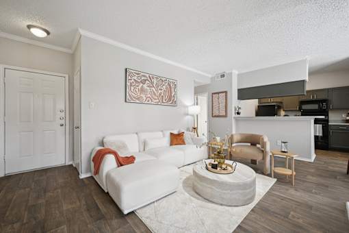 A living room with a white couch and a coffee table.