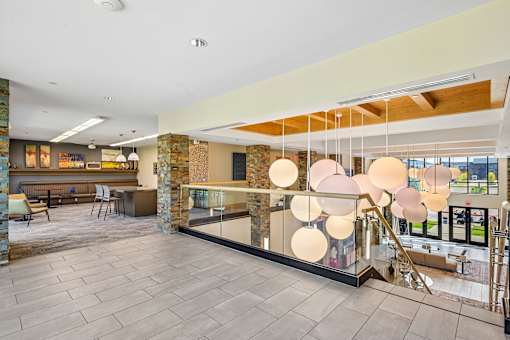 A modern interior space with a stone wall and a glass barrier.
