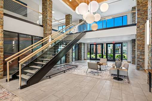 A modern interior with a staircase and a seating area.