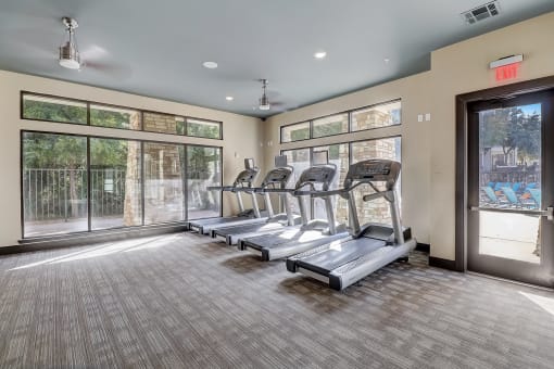 the preserve at ballantyne commons fitness room with cardio machines and windows