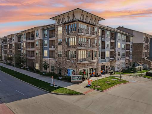 Apartment complex with a sign that says "ALMA".