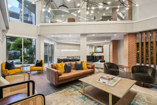A modern living room with a glass ceiling and a large window.