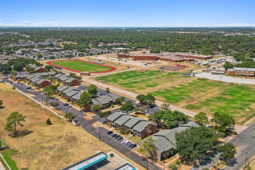 arial view of the campus with the football field and soccer field in the foreground