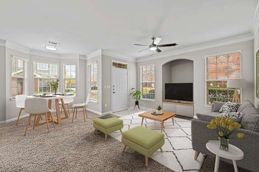 a living room with a couch and a table with chairs