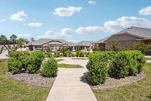 A residential area with houses and green bushes.
