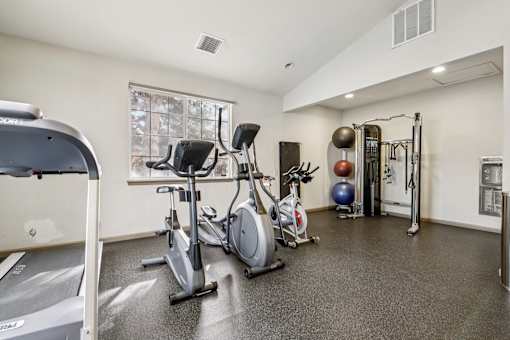 A well-equipped gym with treadmills, exercise bikes, and free weights.