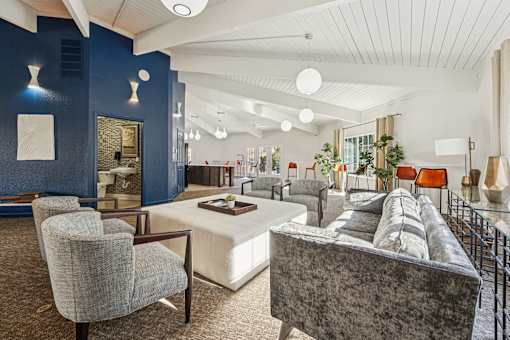 A living room with a grey couch and a white coffee table.