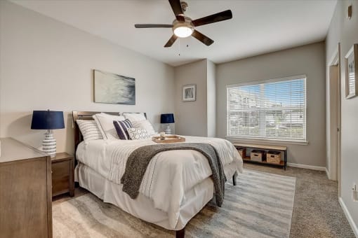 a bedroom with a bed and a ceiling fan