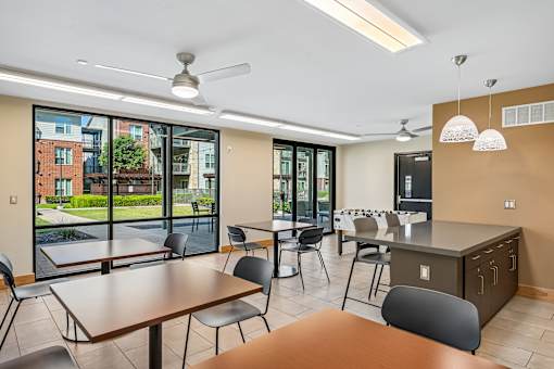 A modern kitchen and dining area with a view of the outside.