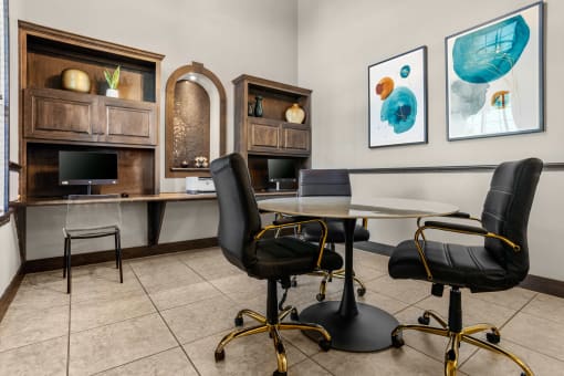 a meeting room with a table and chairs