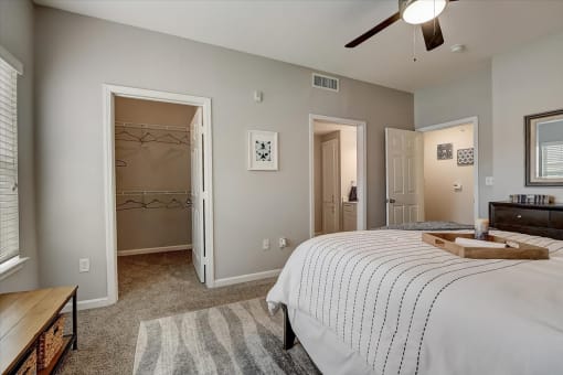 a bedroom with a large bed and a ceiling fan