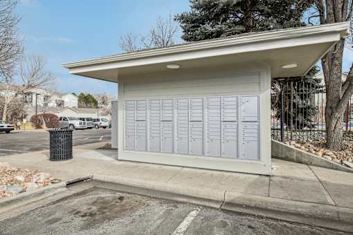 A parking garage with a trash can in front of it.