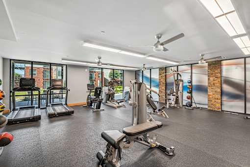 A spacious gym with a variety of equipment including treadmills, weights, and exercise machines.