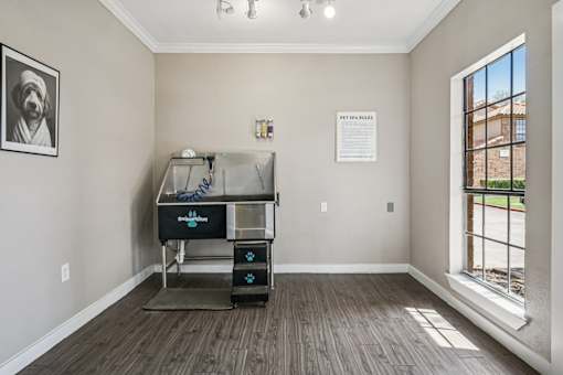 A room with a window and a piece of paper on the wall.