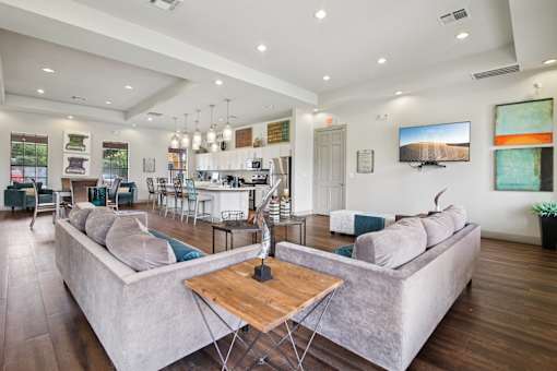 A modern living room with a large grey sofa and a wooden coffee table.