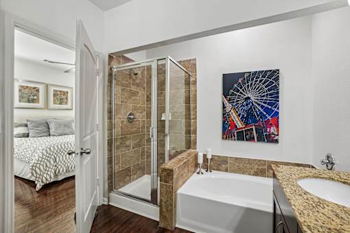A bathroom with a large tub and a painting on the wall.