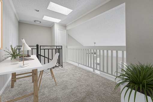 a home office with a white desk and a balcony