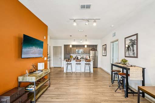 A modern kitchen with a dining table and chairs.