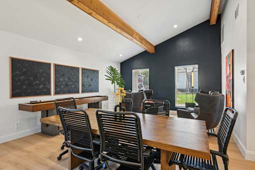 A conference room with a long table and chairs.