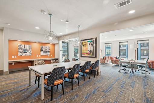A conference room with a long table and chairs.