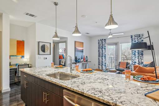 A kitchen with a marble countertop and modern appliances.