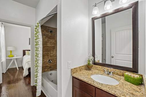 A bathroom with a brown tub and a white sink.