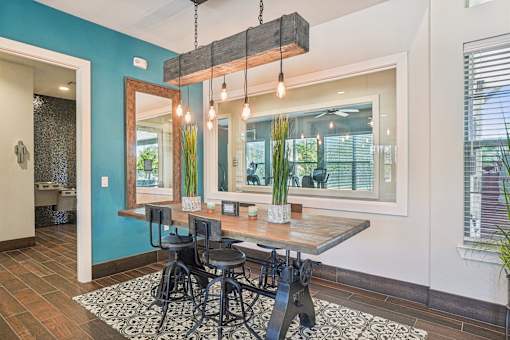 A dining room with a wooden table and chairs.