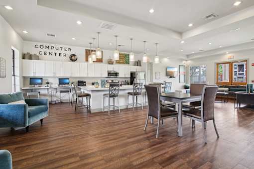 A room with a computer center and a bar area.
