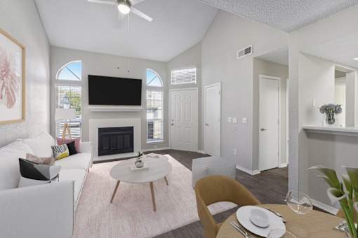 a living room with white furniture and a fireplace