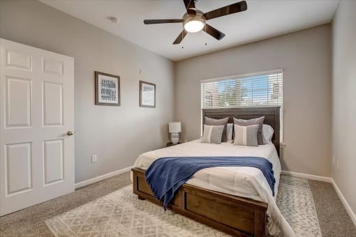 a bedroom with a large bed and a ceiling fan
