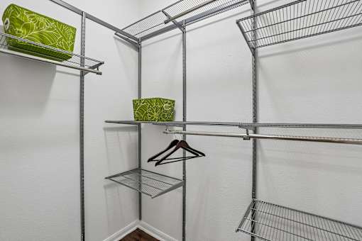 A white closet with a shelf and a hanger.
