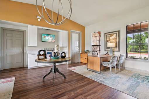A dining room with a round table and chairs.