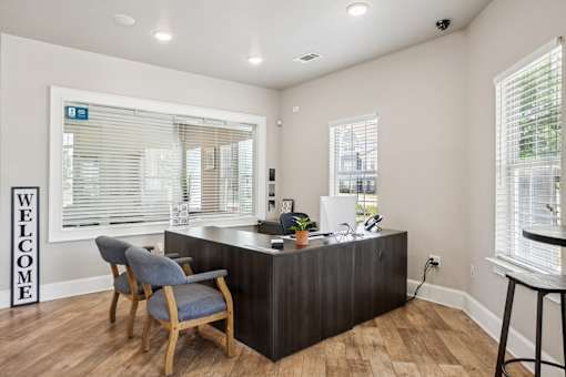 A reception area with a wooden desk and a blue chair.
