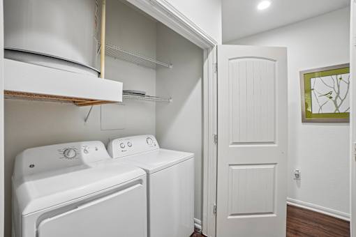 A white laundry room with a washer and dryer.