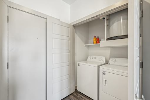 A white laundry room with a washer and dryer.