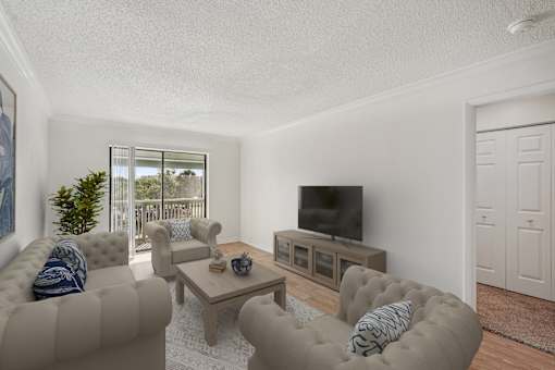 A living room with a grey sofa, a wooden coffee table, and a television.