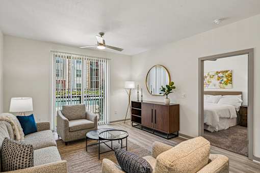 A living room with a sofa, armchair, and a coffee table.